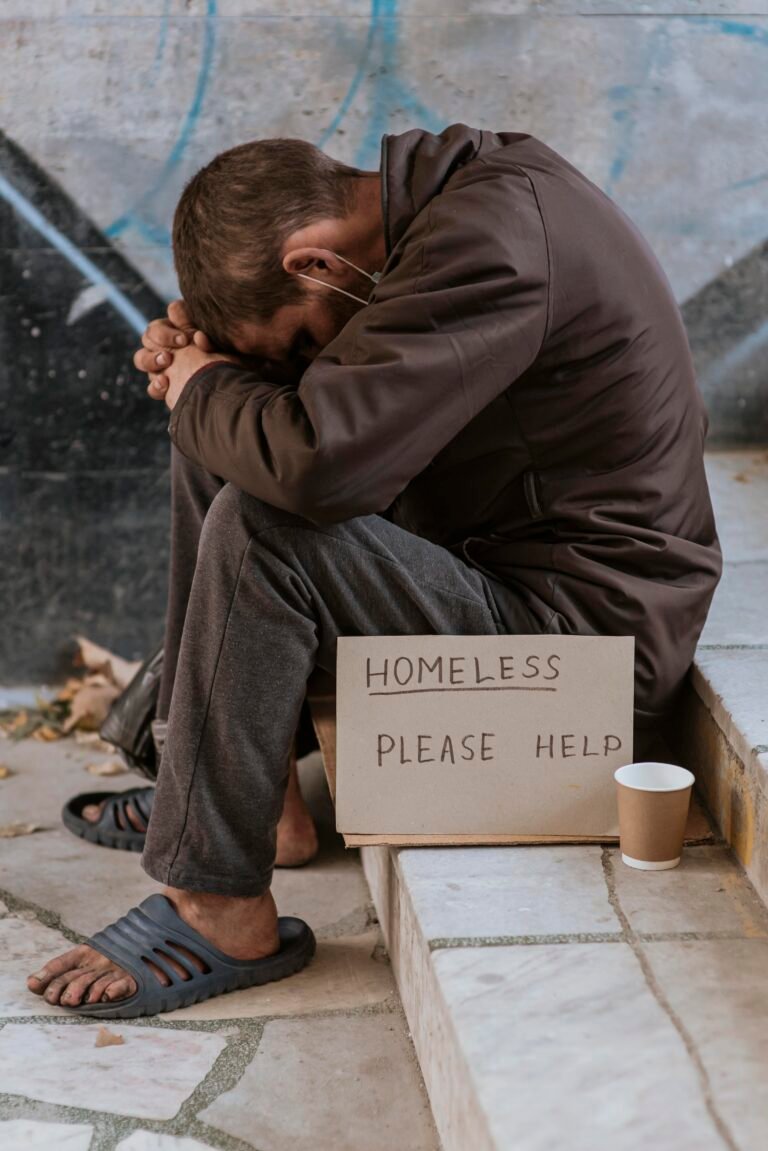 side-view-homeless-man-stairs-with-cup-help-sign